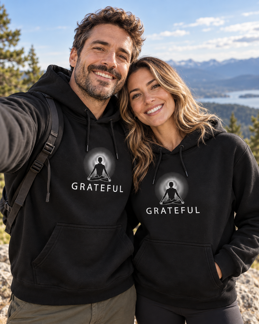 Man and woman wearing black Grateful hoodies outdoors
